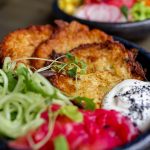 Crispy zucchini fritters with fresh salad and yoghurt dip